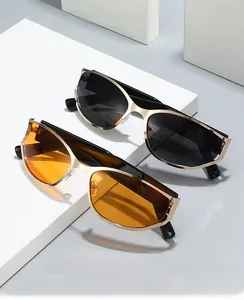 Detail of 2024 futuristic oval sunglasses with gold metal frames and tinted lenses