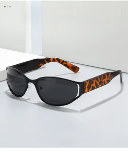 Detail of trendy oval sunglasses featuring tortoiseshell temples and sleek black frames