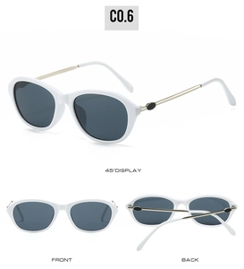 Dettagli di occhiali da sole cat-eye retrò con montura bianca e lenti grigio scuro