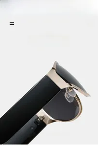 Detail of lightweight oval sunglasses featuring gold metal frame and flexible black temple