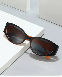 Detail of vintage cat-eye sunglasses with black frame and vibrant orange interior contrast