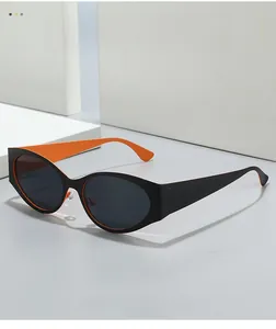 Macro detail of oval cat-eye sunglasses with black frame and vibrant orange interior