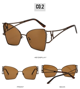 Détail de lunettes soleil polygonales avec monture bronze et branches ajourées chic