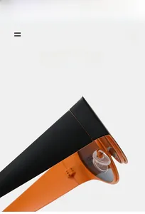 Close-up of vibrant orange oval sunglasses frame with durable metal hinges