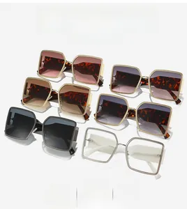 Detail view of woven texture metal frames on stylish oversized square sunglasses