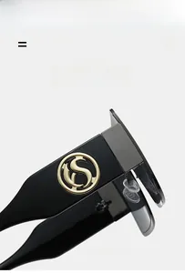Close-up of black sunglasses temple with golden S-logo metal piece and high gloss finish