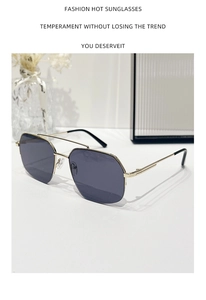 Detailed close-up of champagne gold metal double-bridge sunglasses with dark purple lenses