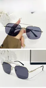 Detail of grey-purple hexagonal lenses and golden double bridge metal sunglasses