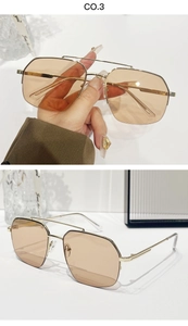 Detail view of gold double-bridge aviator sunglasses with gradient brown lenses