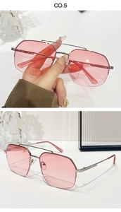 Close-up of pink oversized polygon sunglasses with silver metal double bridge frame