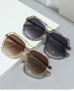 Detail view of double bridge fashion glasses frames in transparent tea and grey colors