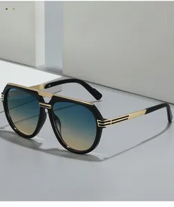 Close-up of pilot sunglasses with black frame, gold metal accents and gradient lenses