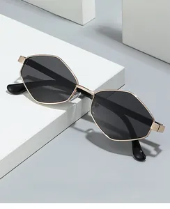 Detailed view of gold irregular metal polygon sunglasses with dark polarized lenses