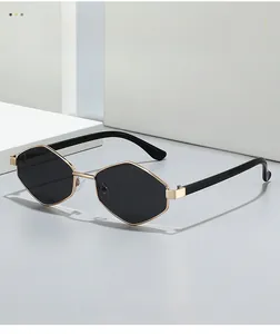 Macro detail of geometric gold metal frame and black lenses on modern sunglasses