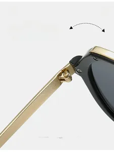 Detailed close-up of durable texture metal hinge on stylish black and gold sunglasses