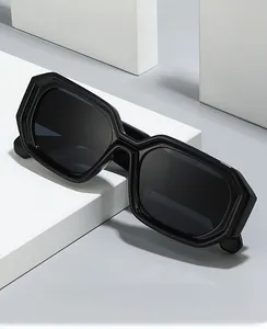 Detail of black geometric octagon sunglasses with dark lenses on a white display block