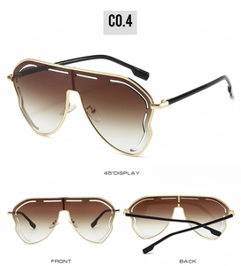 Détail des lunettes de soleil dorées avec verres dégradés marron et découpes blanches en haut