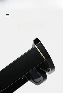 Macro detail of sunglasses hinge showing black acetate frame and gold metal inlay