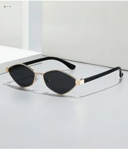 Detailed close-up of polarized cat-eye sunglasses with slim gold metal frame on white stairs