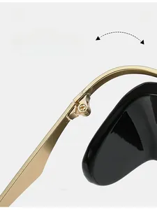 Macro detail of durable gold metal hinge on sleek black oval sunglasses for women
