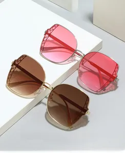 Detail of polygonal eyewear with gold metal frames and mesh hollowed-out temples