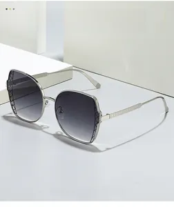 Detail of silver metal frame sunglasses with woven texture and gradient gray lenses