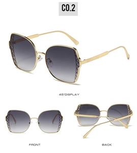 Detail of gold metal sunglasses frame with intricate diamond lattice texture and gradient lenses