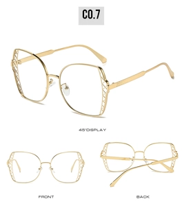 Detail view showing golden metal mesh hollow design on stylish oversized sunglasses frame