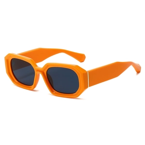Fashionable bright orange geometric thick frame sunglasses with dark lenses and gold accents