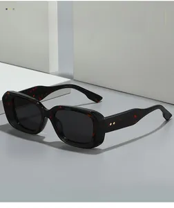 Close-up of vintage square tortoise shell frame sunglasses with gold diamond stud detail