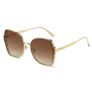 Stylish oversized gold metal sunglasses with brown gradient lenses and quilted texture frames