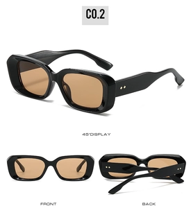 Detail view of vintage square sunglasses with orange lenses and decorative rivets