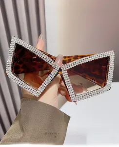 Close-up of tortoise shell cat-eye sunglasses with sparkling rhinestone embellishments