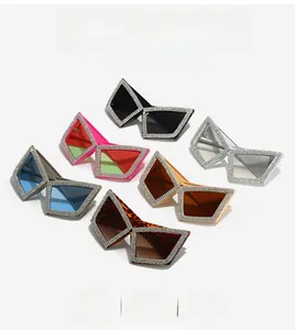 Macro detail of oversized cat-eye sunglasses featuring hand-set rhinestones on frames