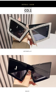 Close-up of oversized cat-eye sunglasses with luxury rhinestone inlay on black frames