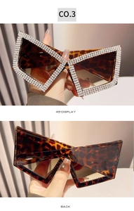 Detail of leopard print cat-eye sunglasses with rhinestone frames and brown lenses