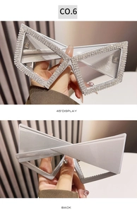 Detail view of silver cat-eye sunglasses with rhinestone-encrusted butterfly frames