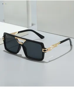 Detail of golden triangular metal bridge on square oversized two-tone sunglasses