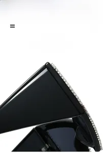 Detail of black oversized sunglasses with crystal-studded temples and glossy resin texture