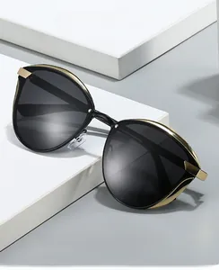 Detailed view of women's round polarized sunglasses with gold metal frame accents