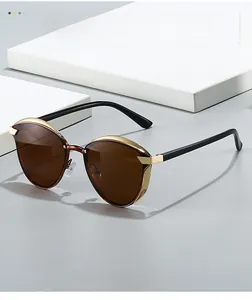Detail of brown polarized lenses with premium gold metal trim on vintage round sunglasses