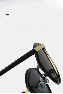 Detail of polarized sunglasses hinge showing golden metal hardware and lightweight black frame