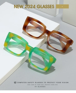 Detail of vintage square anti-blue light glasses with tortoiseshell and marble patterns