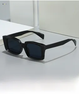 Close-up of modern black square sunglasses with thick glossy frames and dark lenses