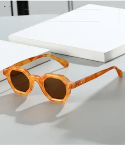 Close-up of retro hexagonal sunglasses with tortoise shell texture and brown lenses