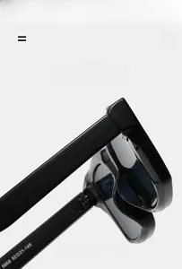 Macro shot of durable hinges and size parameters 52-21-145 on thick black sunglasses frames