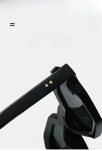 Detail of black polygon sunglasses frame with metallic rivets and durable hinges