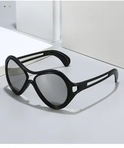 Detail of black cat-eye sunglasses featuring unique hollowed-out geometric temples
