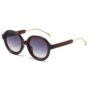Occhiali da sole rotondi bordeaux oversize con lenti sfumate e stanghette dorate