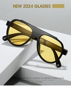 Close-up of black frame sunglasses with yellow lenses and printed size specifications